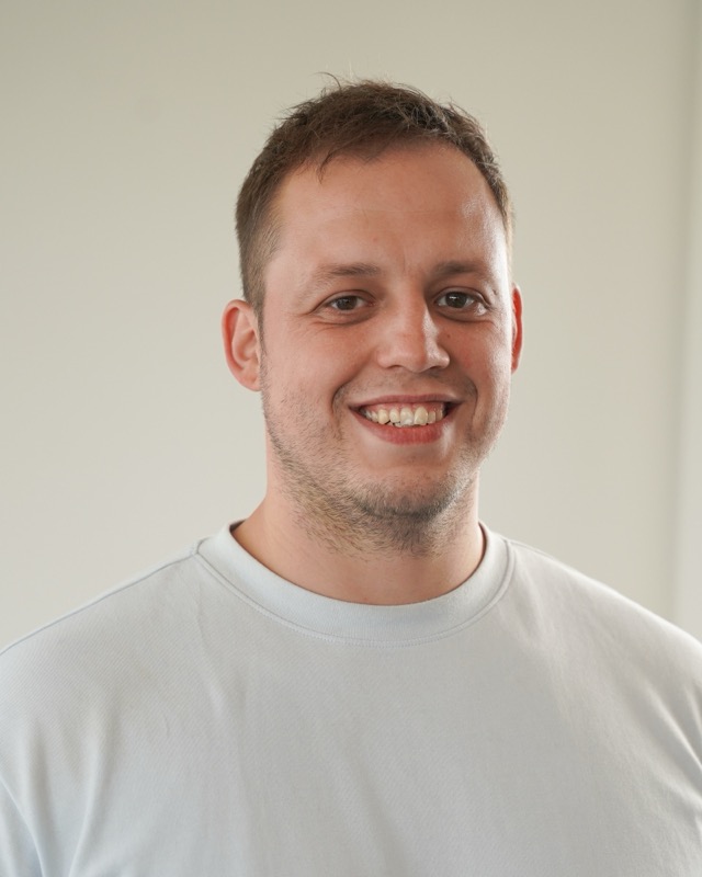 Portret van Jari van Bakel voor een lichte wand.